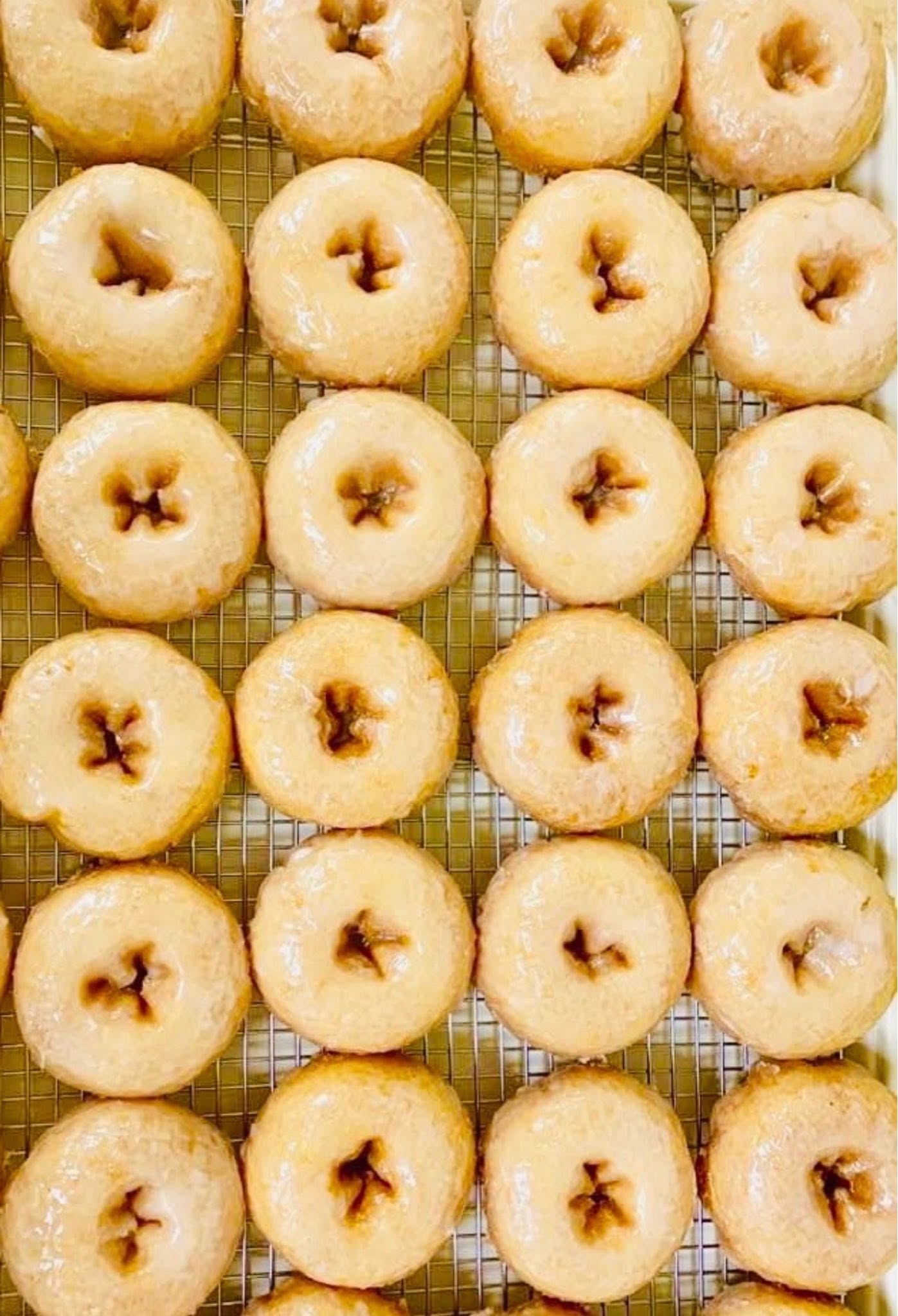 Fresh glazed donuts on a rack